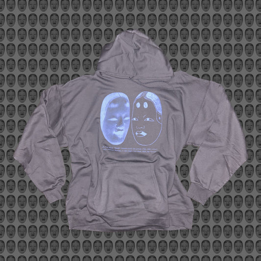 Gray hoodie with a blue face and noh mask design by STUDIO SAISAI on the front against a patterned background